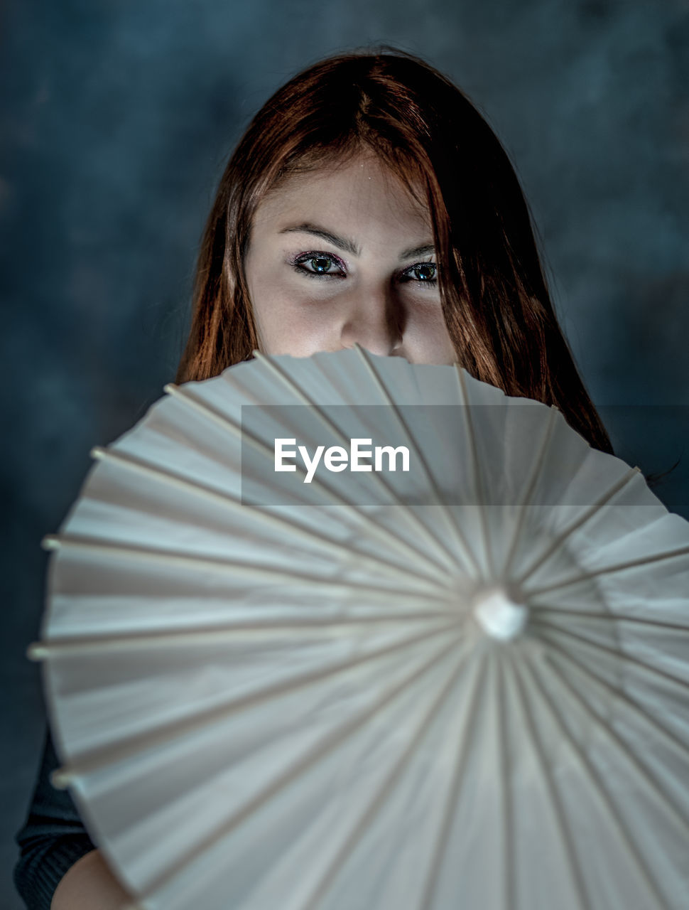 Portrait of woman with drink umbrella