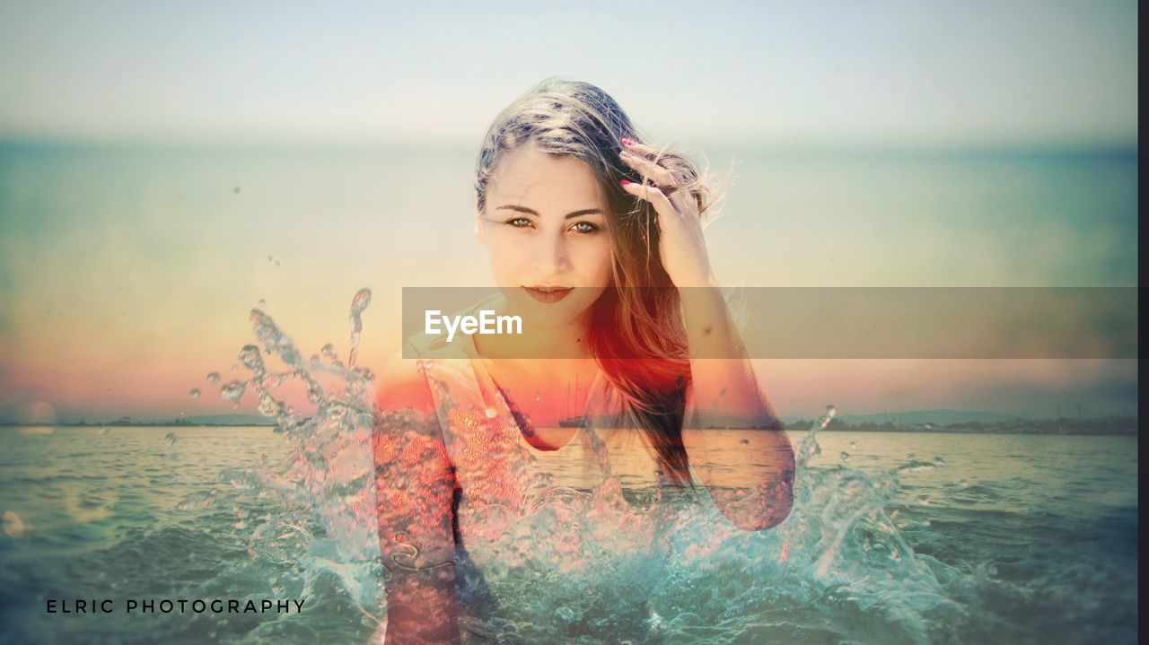 PORTRAIT OF BEAUTIFUL YOUNG WOMAN AT BEACH