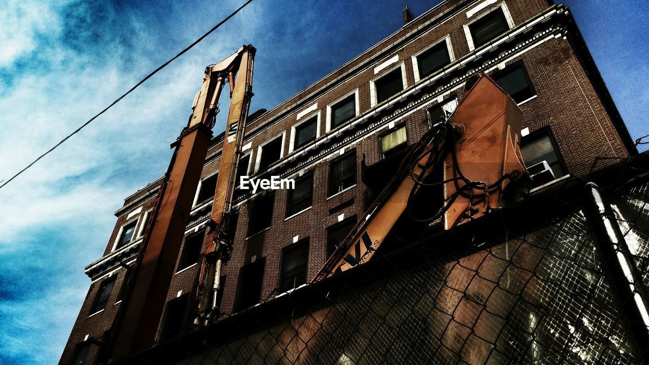 Low angle view of building with crane