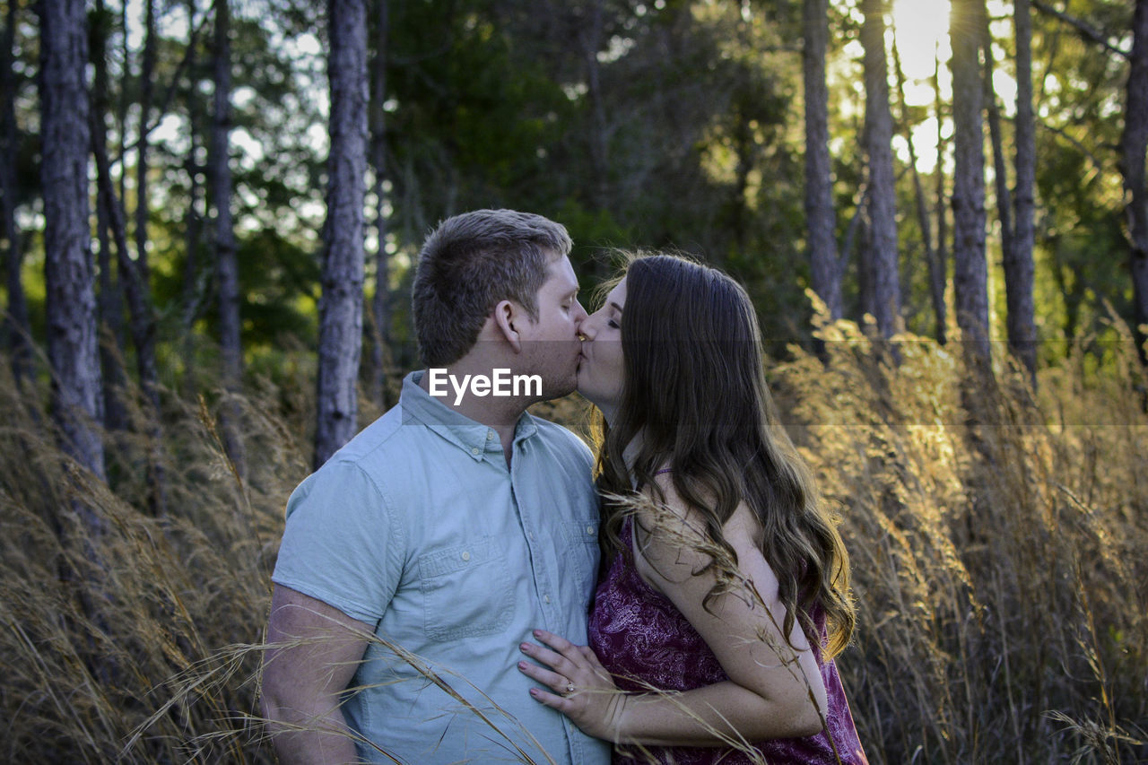 REAR VIEW OF COUPLE AT FOREST