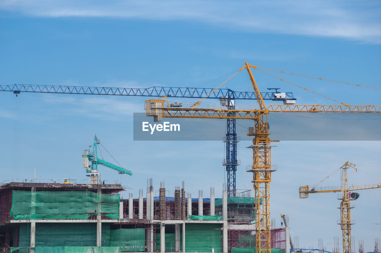 CRANES AT CONSTRUCTION SITE