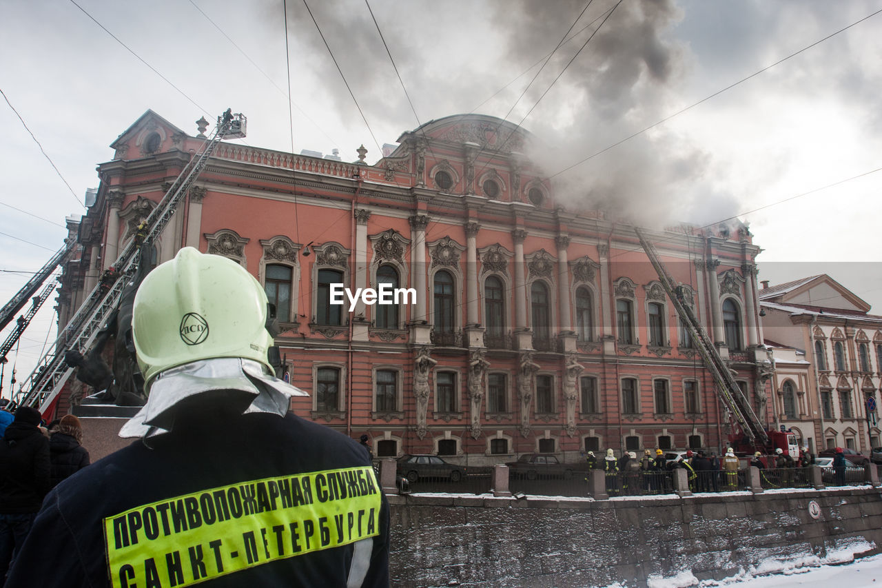 architecture, protection, security, building exterior, government, city, built structure, nature, law, sky, police force, communication, occupation, sign, cloud, accidents and disasters, text