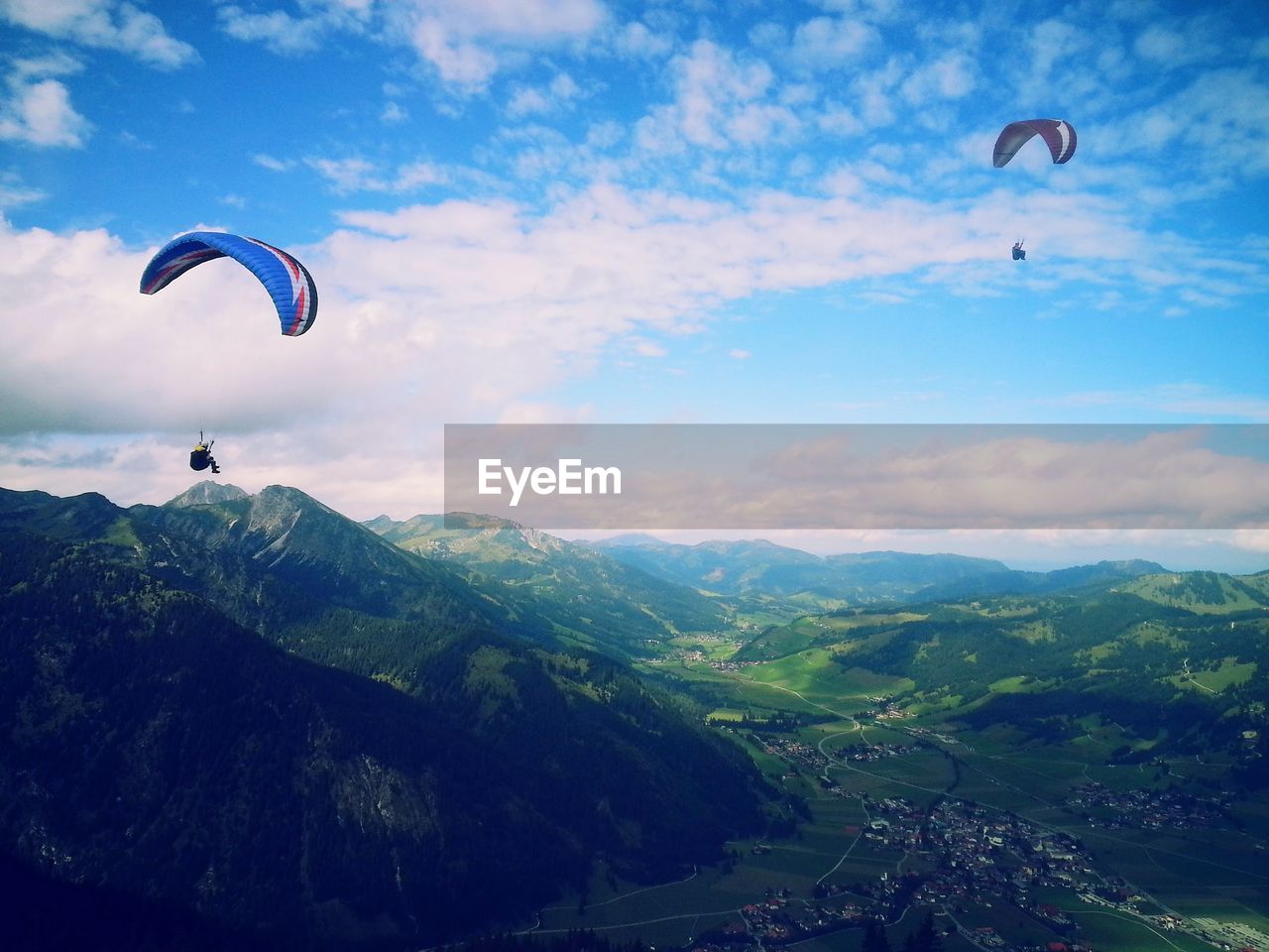 PERSON PARAGLIDING AGAINST MOUNTAIN