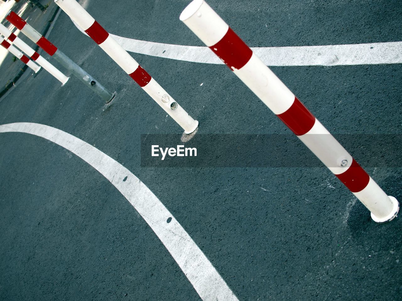 High angle view of bollards and road markings on street