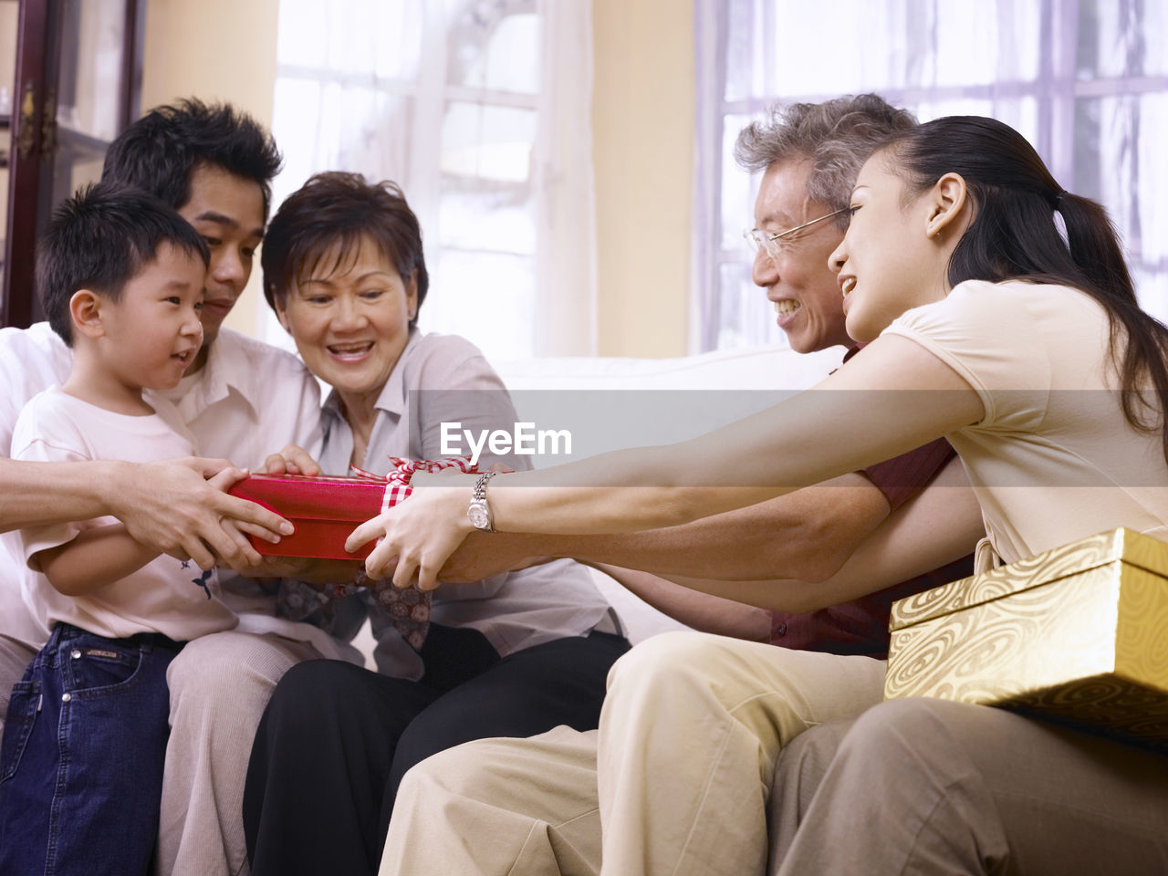 Family giving gift to boy at home