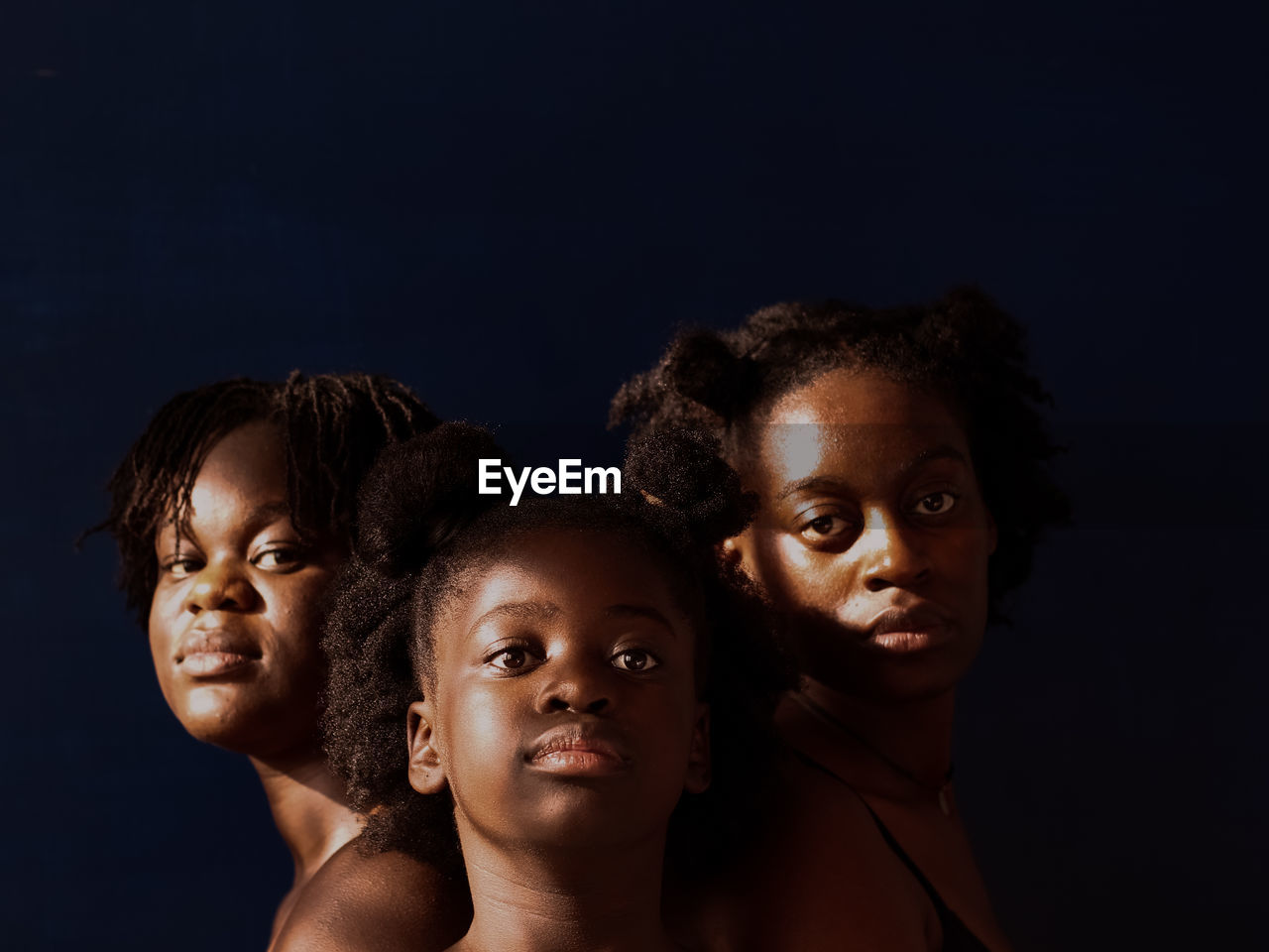 Portrait of people against black background