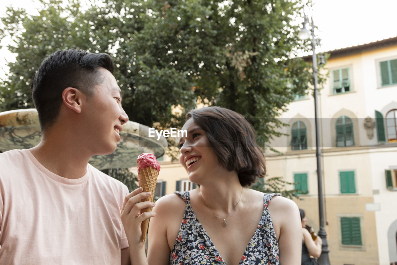 Happy couple enjoying gelato in florence italy