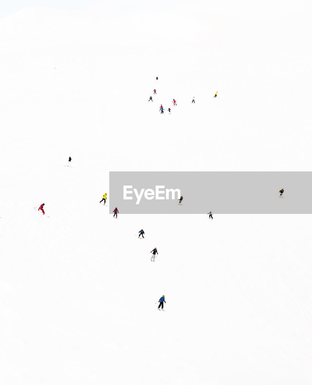 High angle view of people skiing on snow covered land