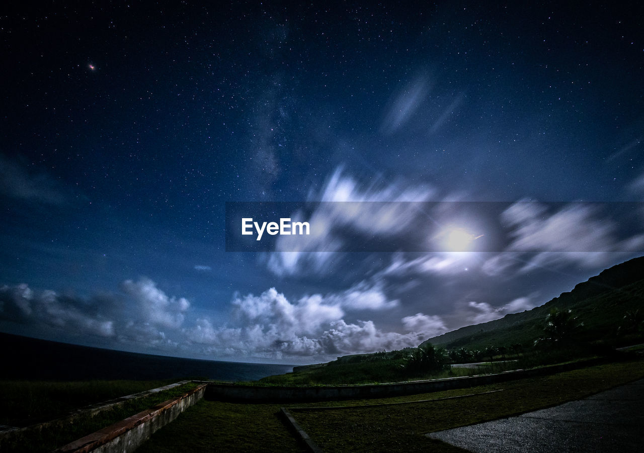 Scenic view of field against sky at night