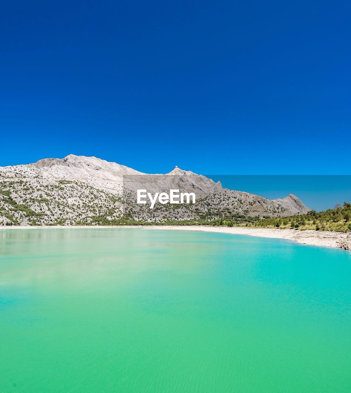 Scenic view of mountains against clear blue sky