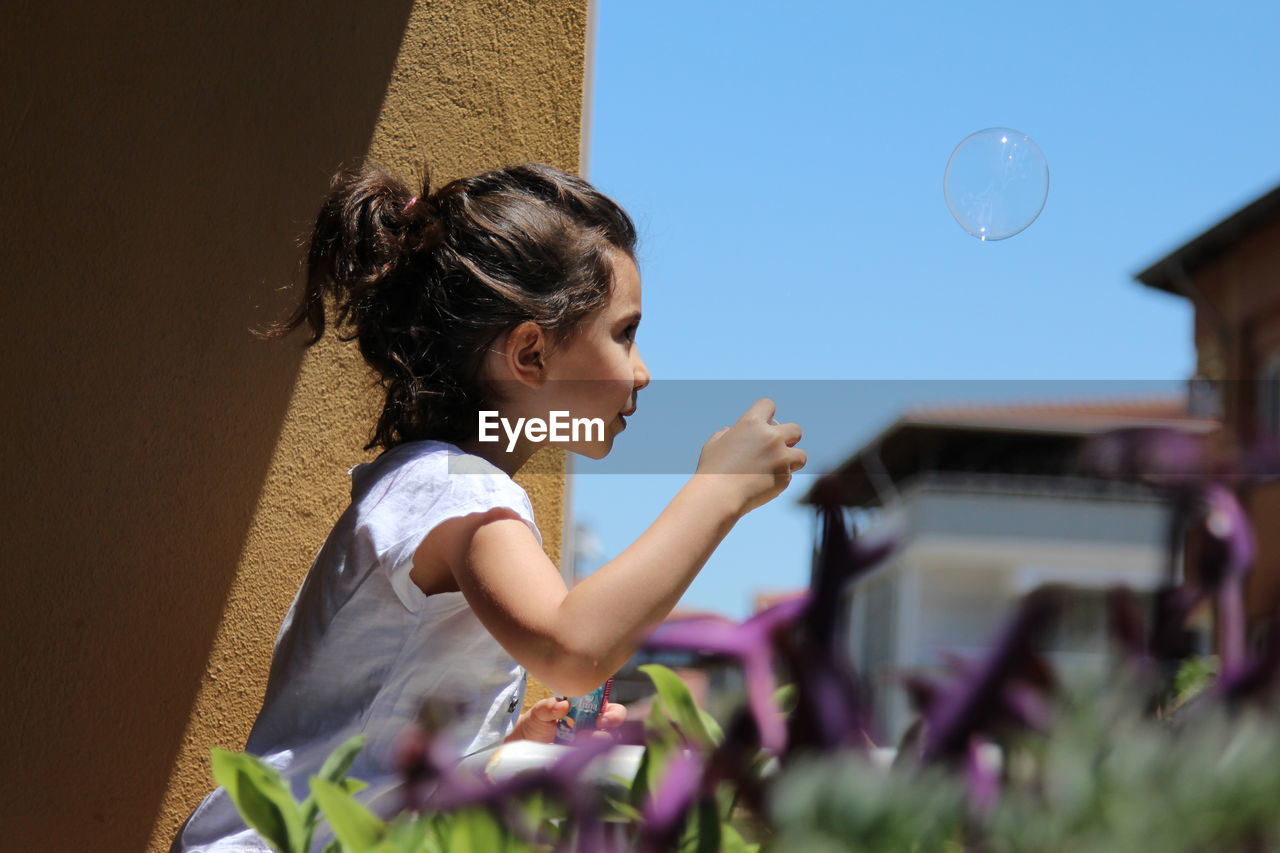 Girl looking at bubbles