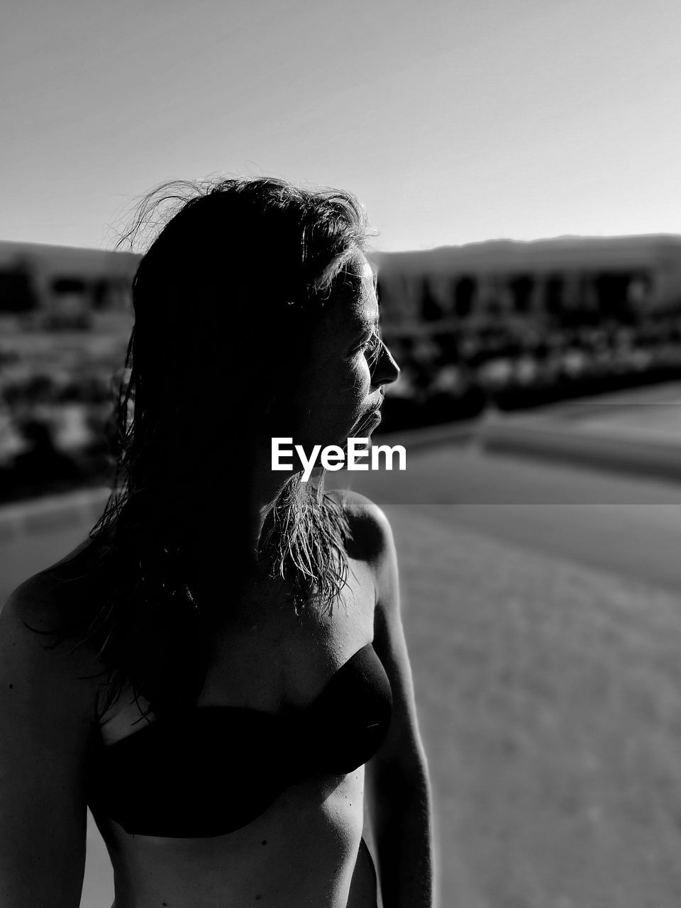 Woman wearing bikini top looking away