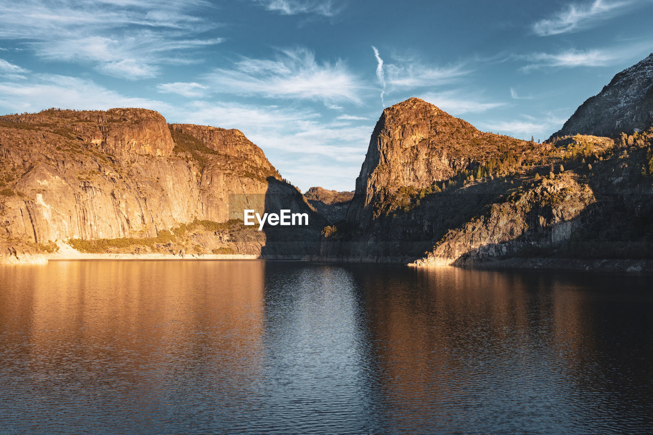 Scenic view of lake and mountains against sky