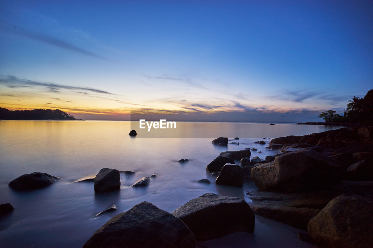 Scenic view of sea against sky at sunset