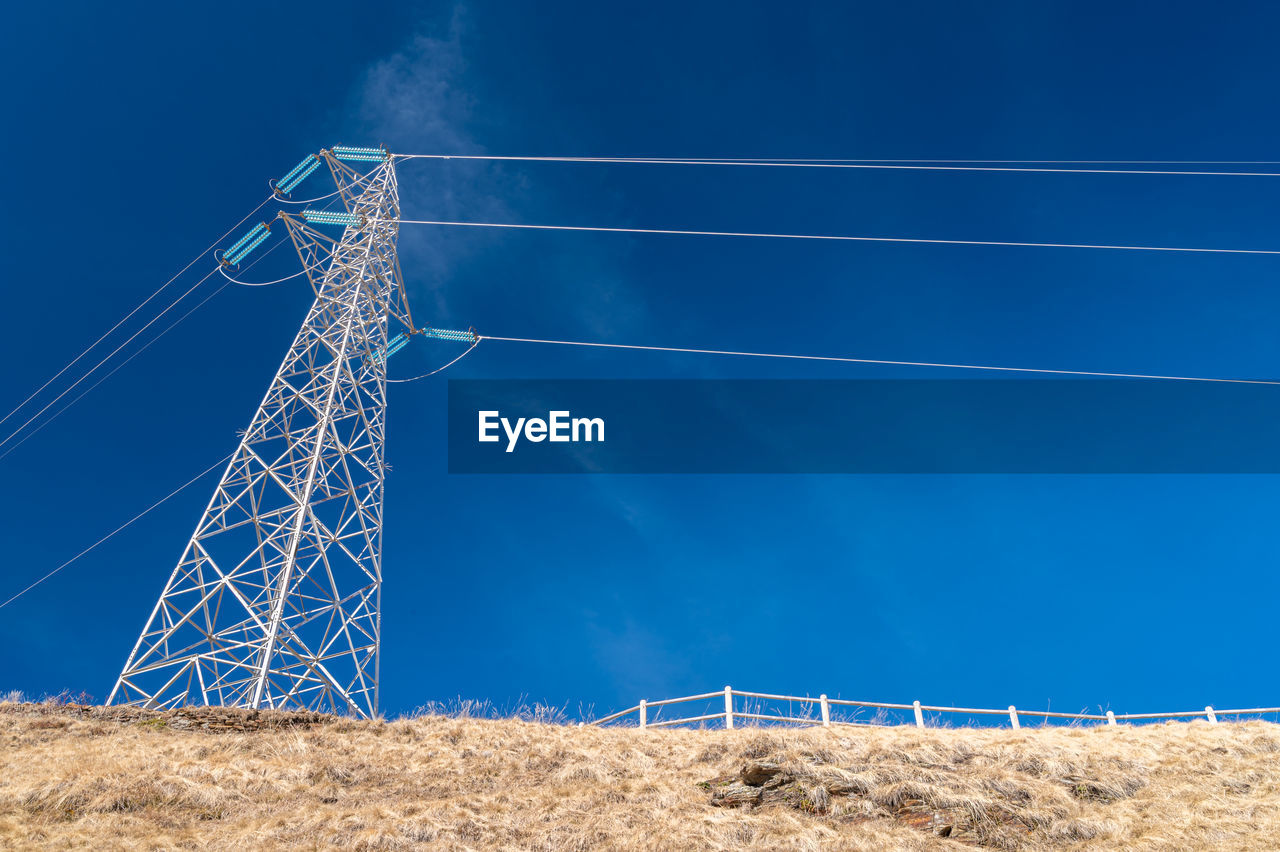 Electricity pylons in a mountain place. origin, transport and need for electricity. eletricity grid.