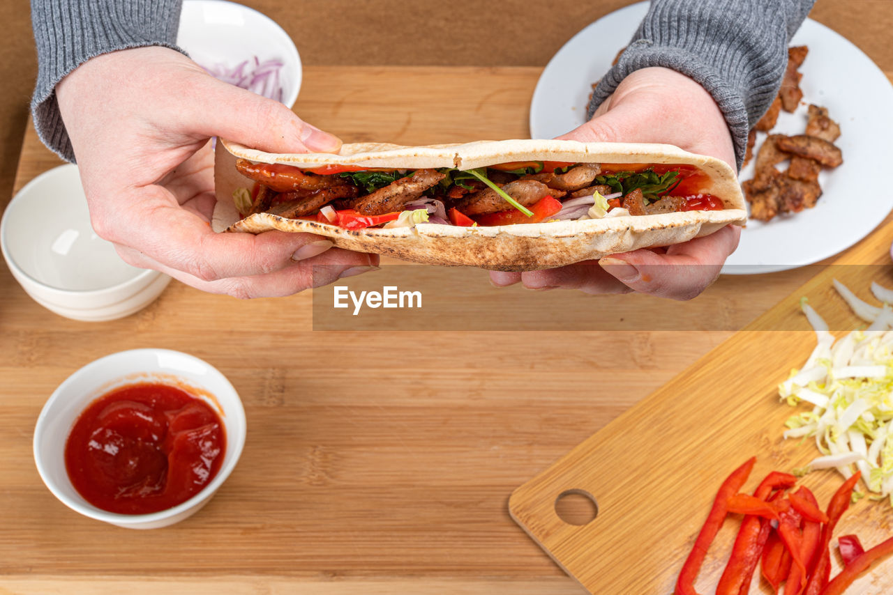 Cropped hand of woman holding food