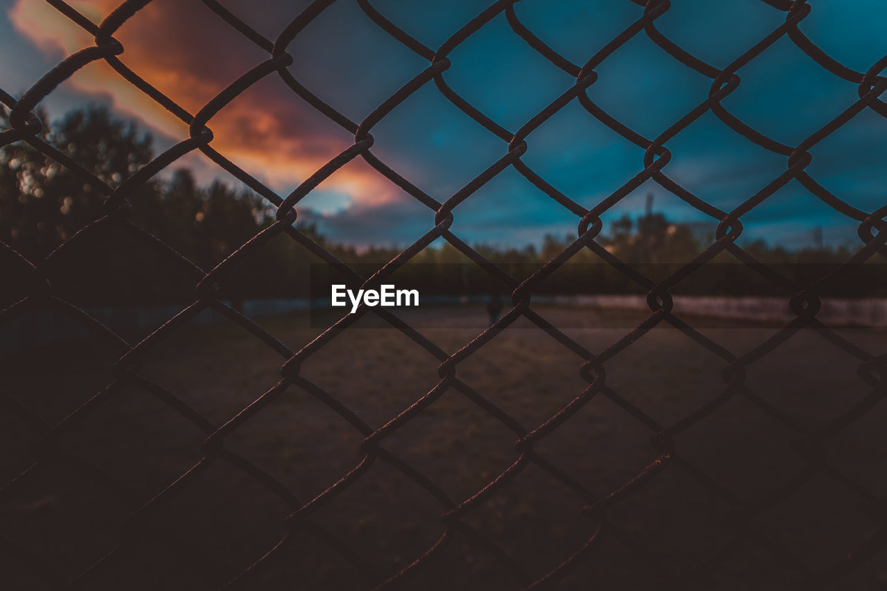 Full frame shot of chainlink fence during dusk