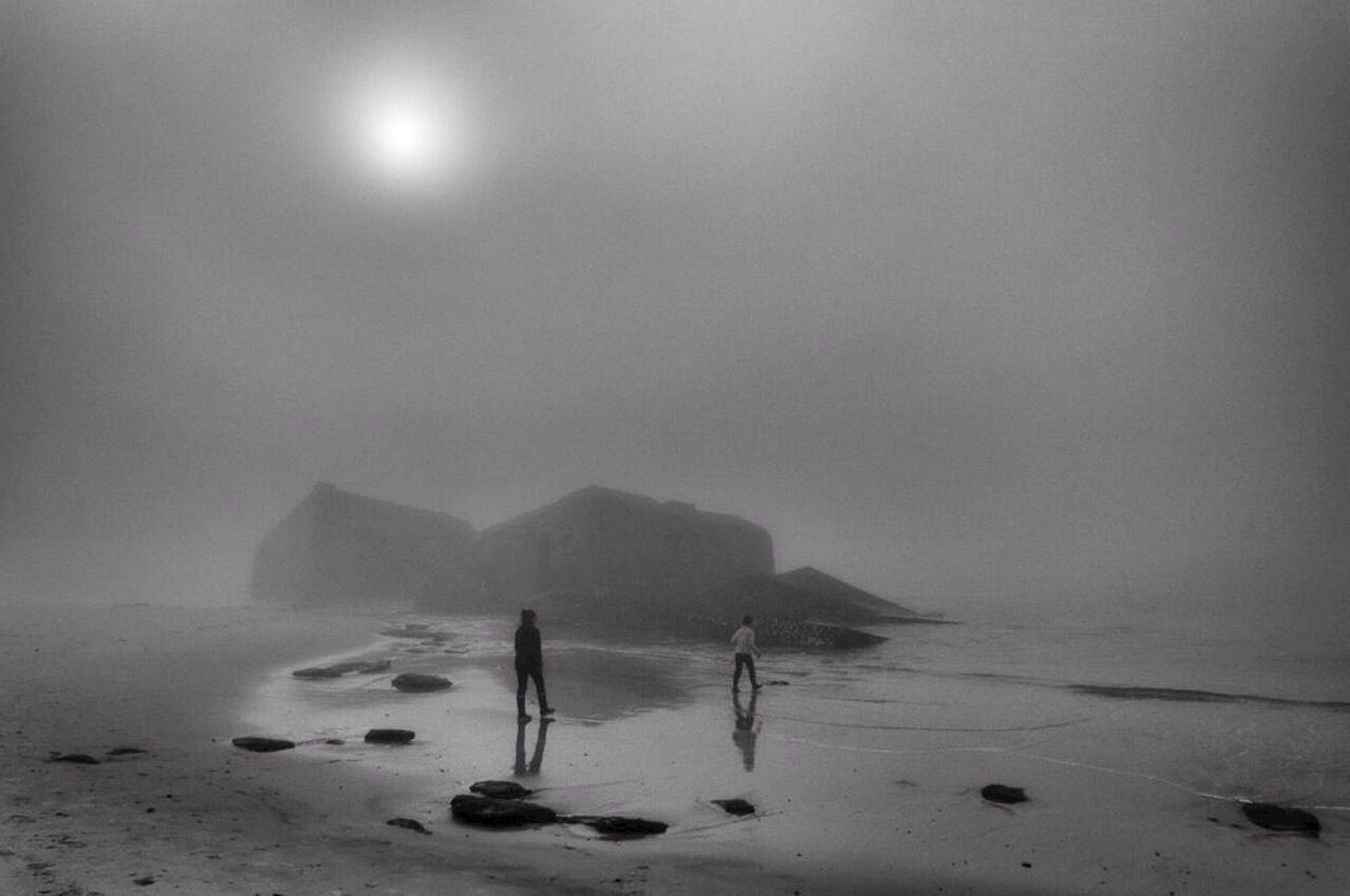 Two people walking on the beach