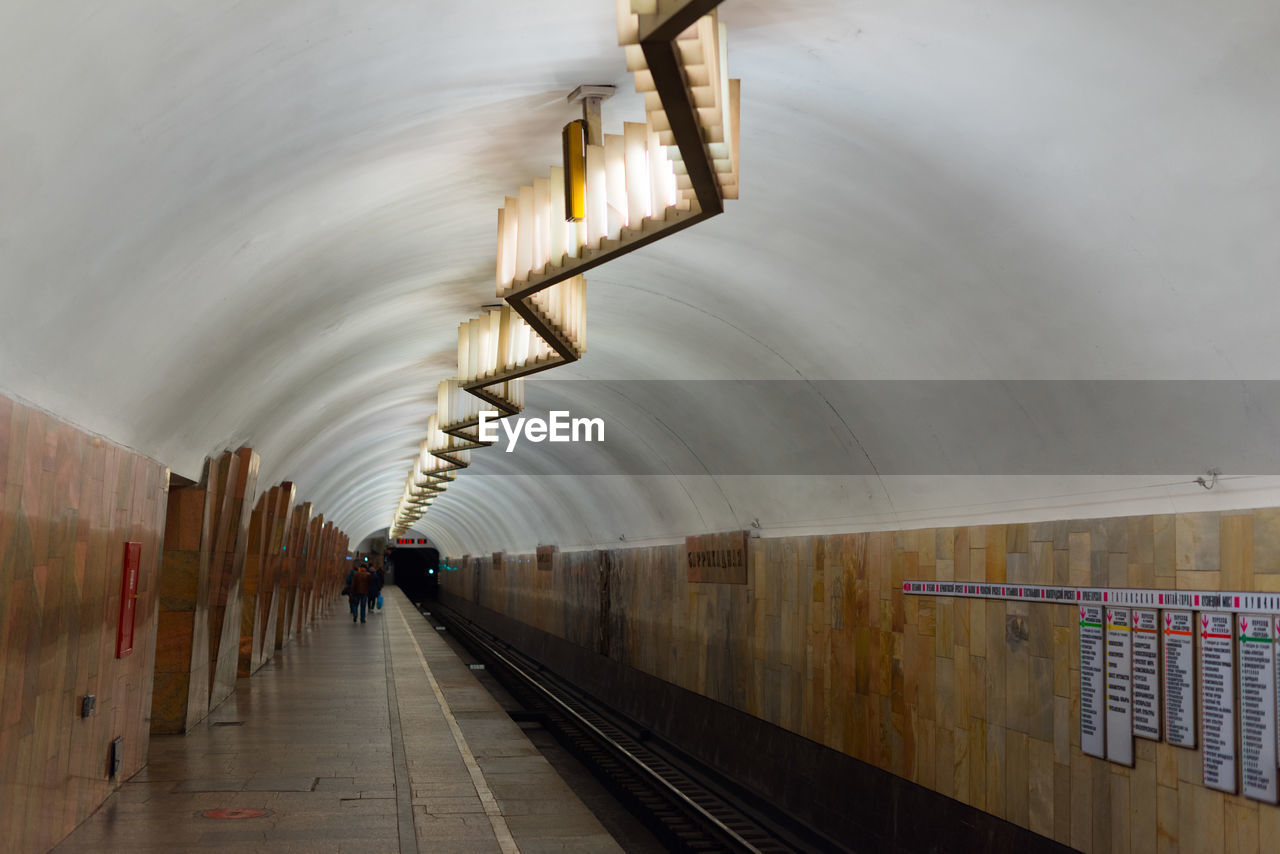 MAN IN ILLUMINATED UNDERGROUND