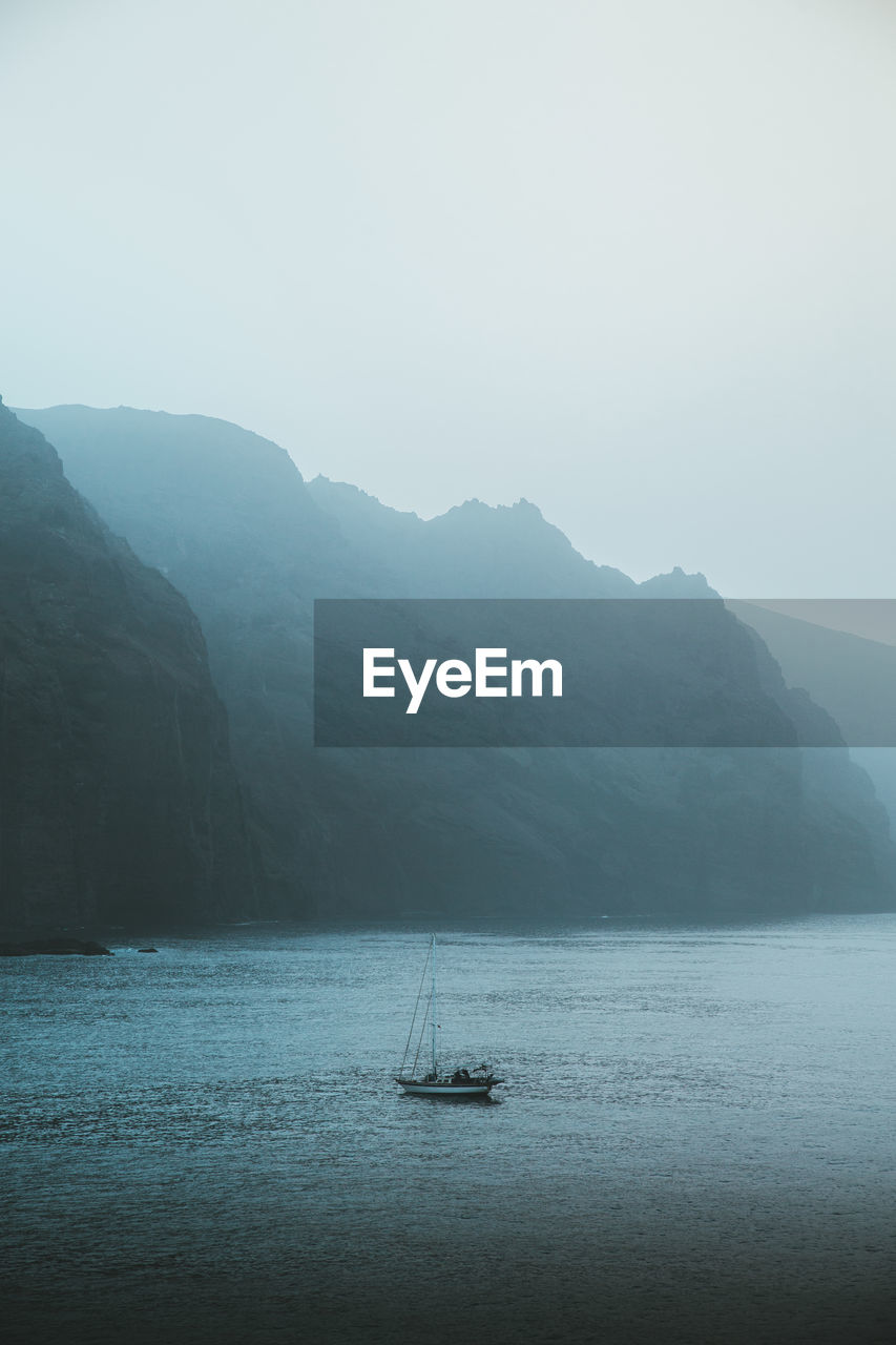 Sailboat in sea against sky