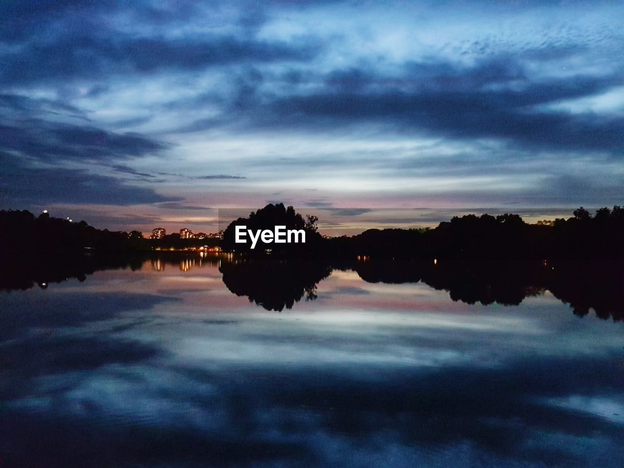 Scenic view of lake against sky at sunset