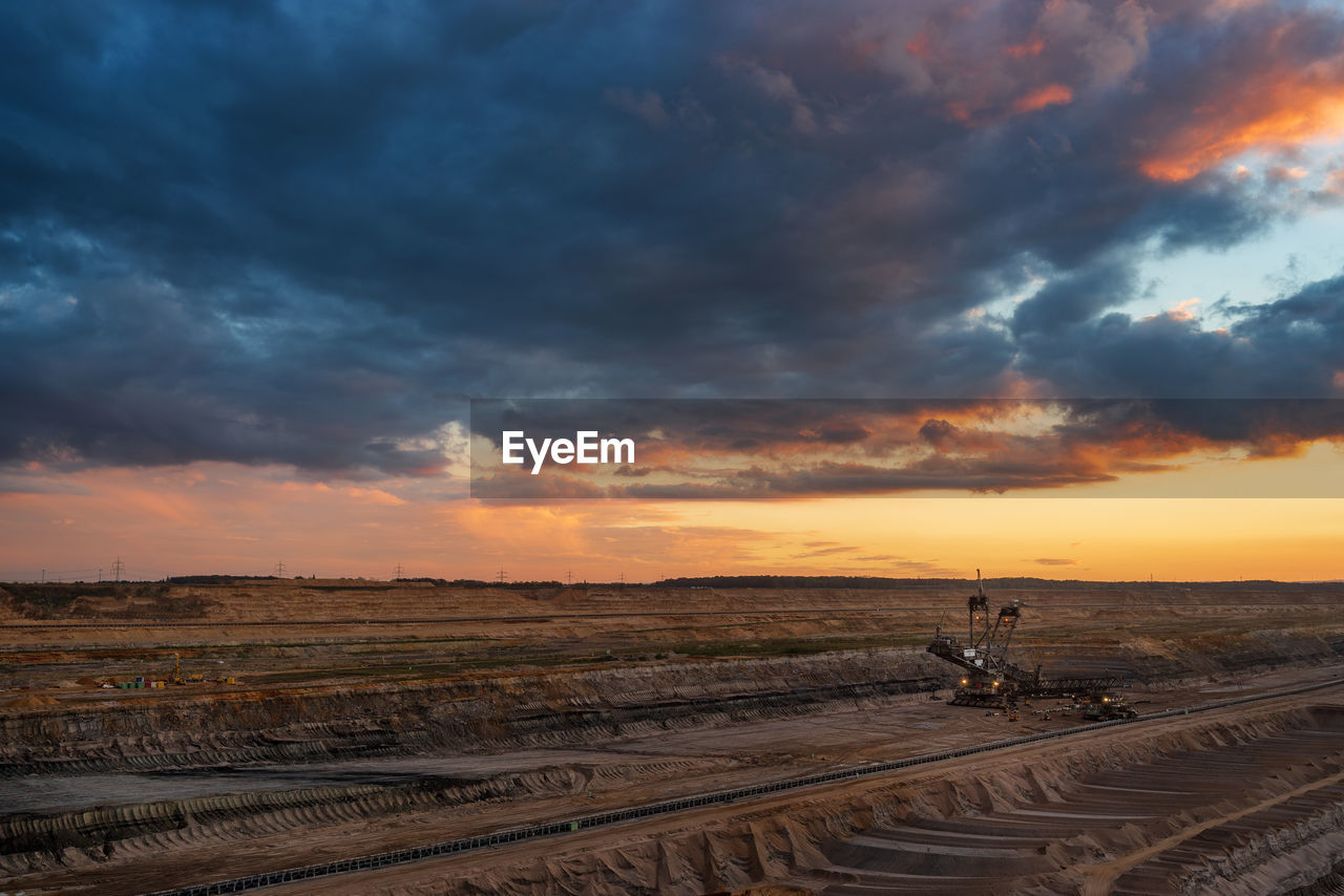 Scenic view of land against sky during sunset