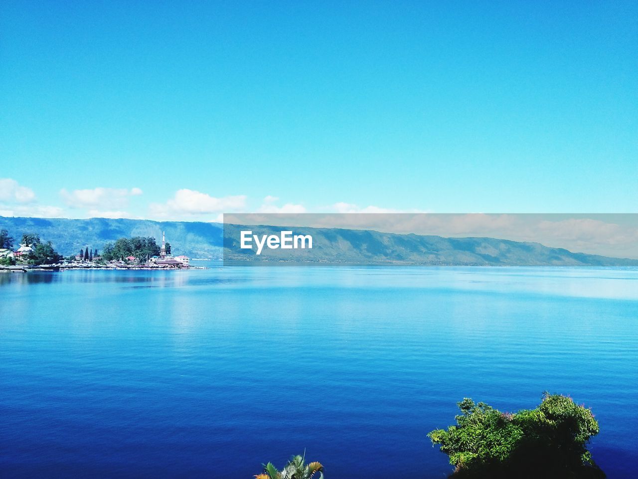 Scenic view of sea against blue sky