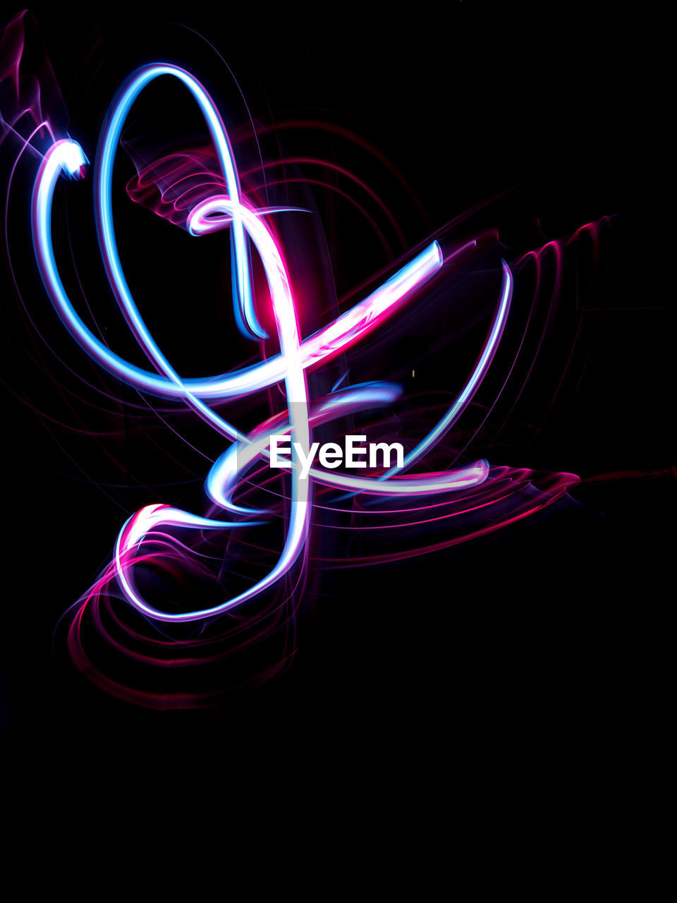 LIGHT PAINTING AGAINST BLACK BACKGROUND AT NIGHT