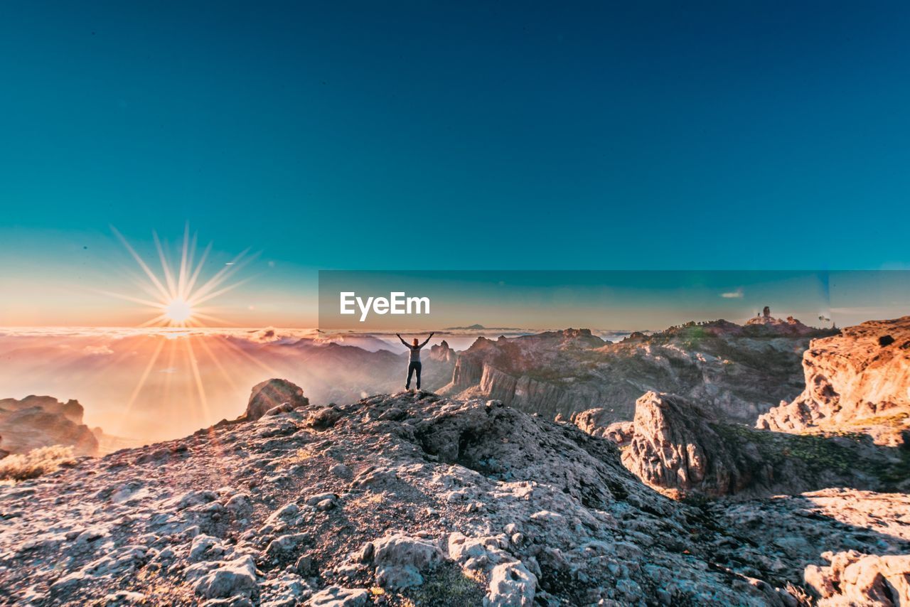 Scenic view of mountains against blue sky during sunset