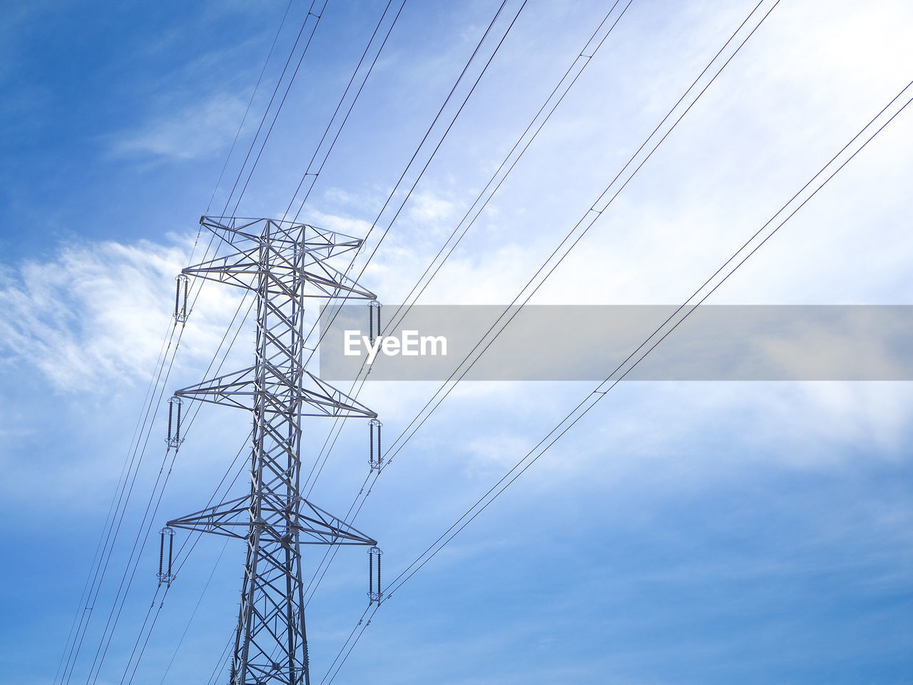 Low angle view of electricity pylon against sky