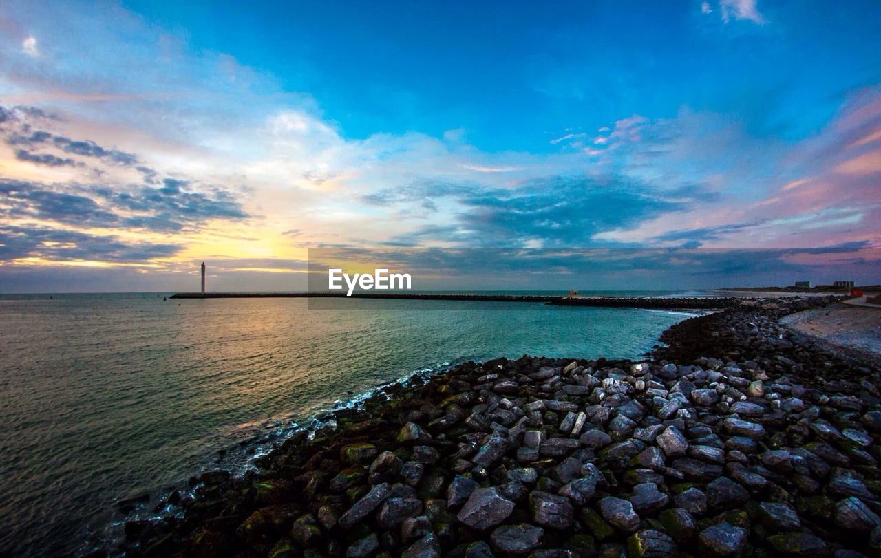 Scenic view of calm sea at sunset