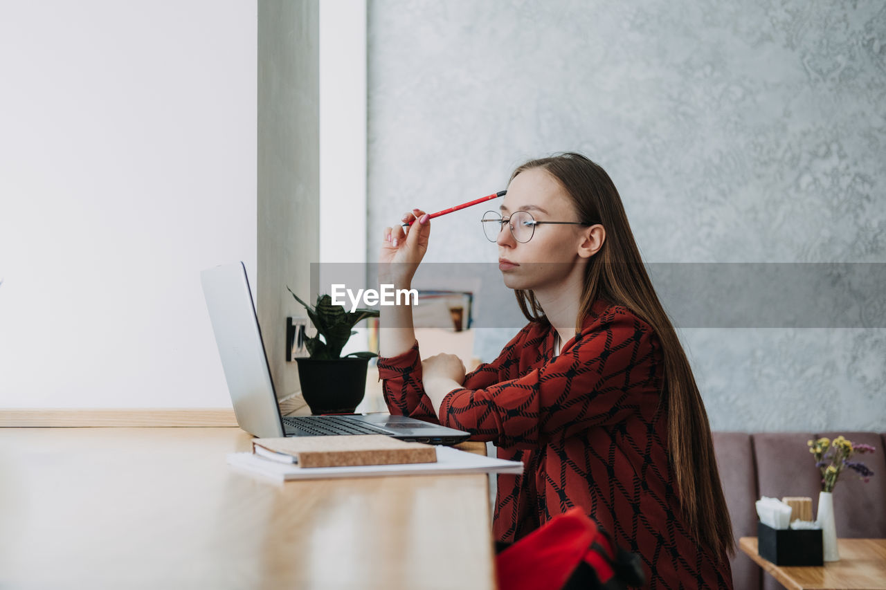 College students mental health. sad and frustrated teenager student girl sitting with laptop and