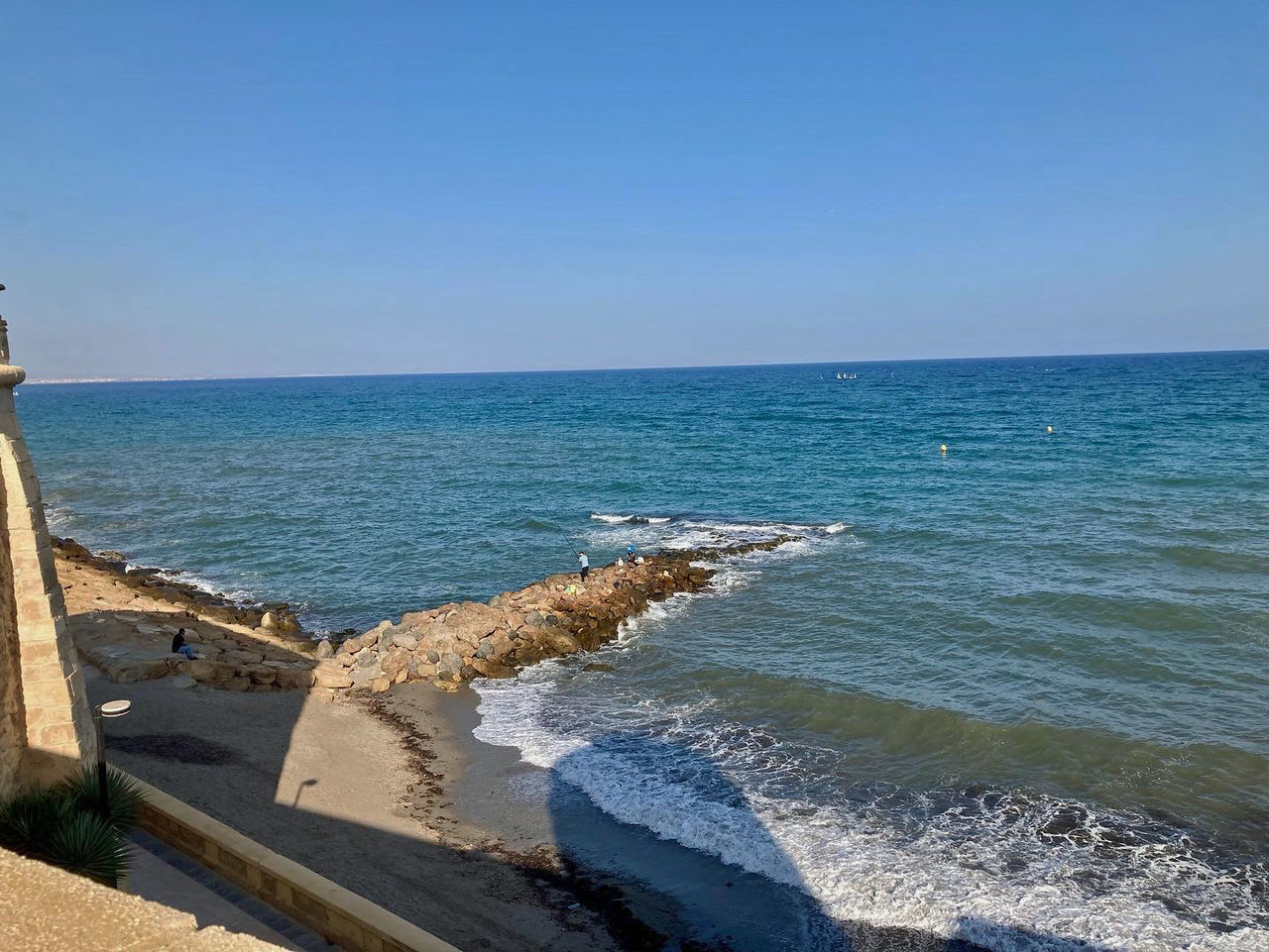 water, sea, sky, vacation, horizon, horizon over water, shore, nature, land, beach, ocean, scenics - nature, clear sky, coast, breakwater, beauty in nature, blue, day, body of water, sunlight, no people, sunny, tranquility, tower, tranquil scene, architecture, travel destinations, cliff, bay, terrain, outdoors, wave, travel, cove, motion, copy space, idyllic, built structure, tourism