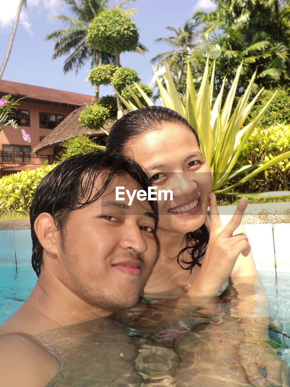 Portrait of smiling couple in swimming pool