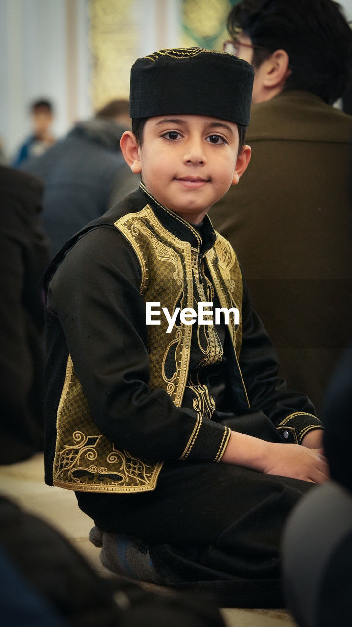 Muslim child boy in traditional clothes at mosque