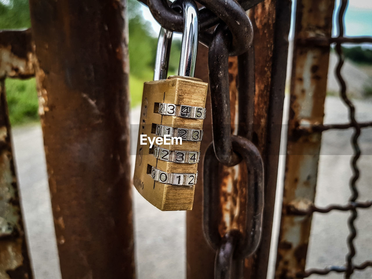 CLOSE-UP OF PADLOCKS ON RUSTY METAL