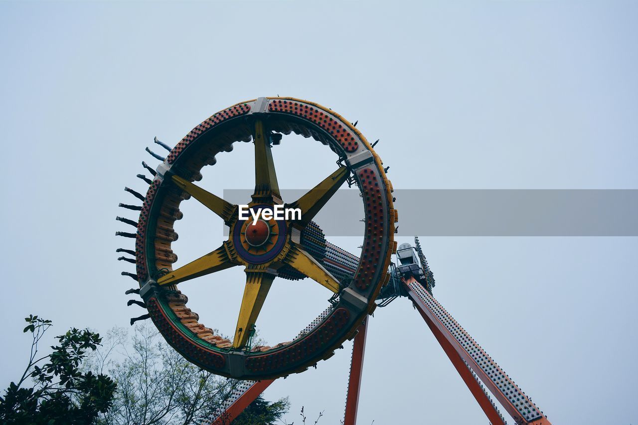 Low angle view of wheel against clear sky