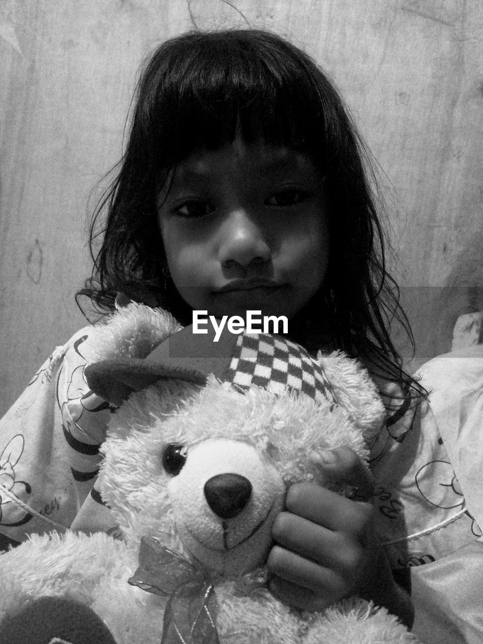 childhood, child, toy, teddy bear, one person, women, female, stuffed toy, person, portrait, black and white, baby, monochrome photography, white, black, indoors, monochrome, front view, human face, holding, looking at camera, cute, lifestyles, toddler, human head, nose, representation, headshot, innocence, emotion, animal representation, waist up