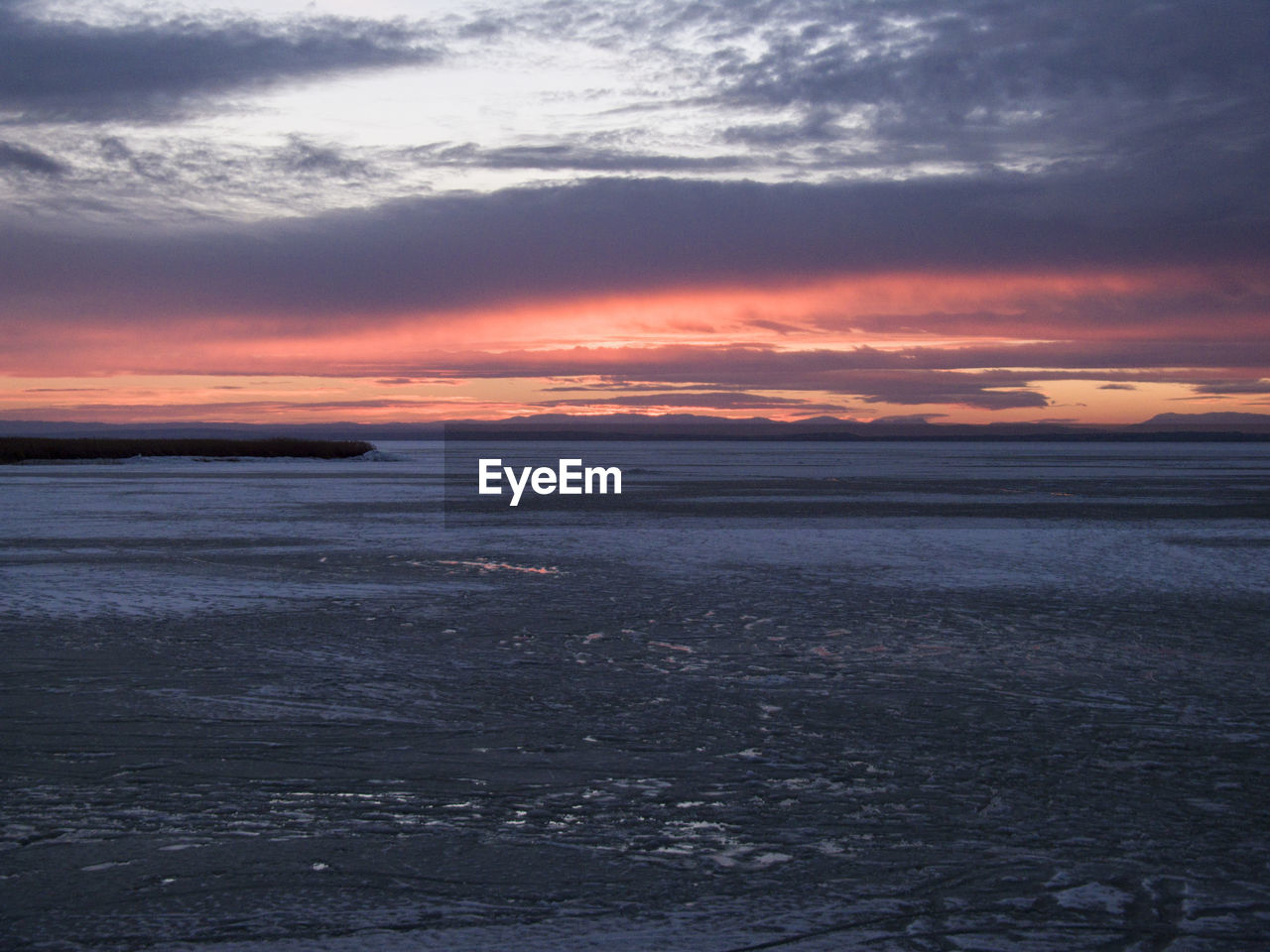 Scenic view of sea against cloudy sky