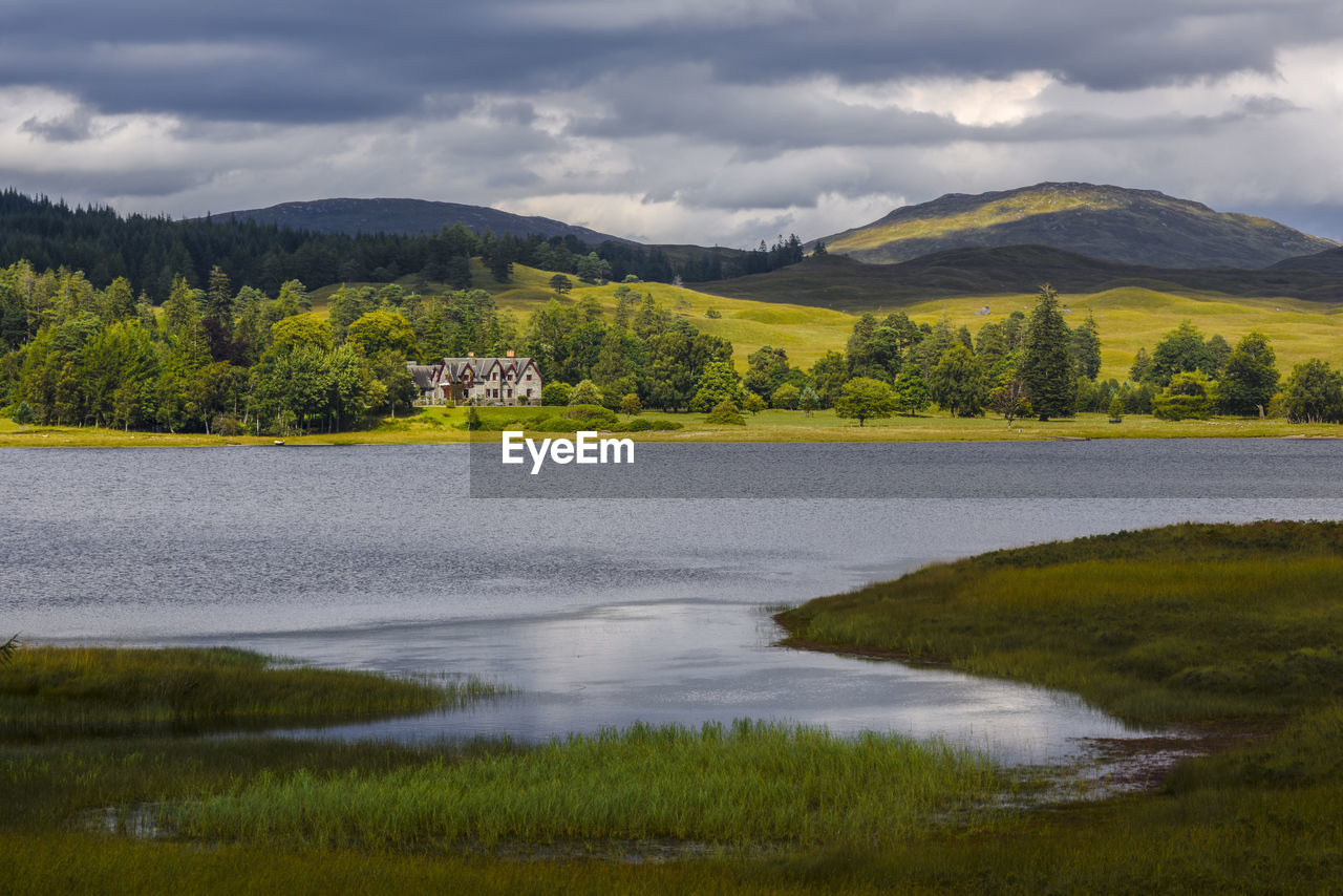 Scenic view of lake and mountains against sky