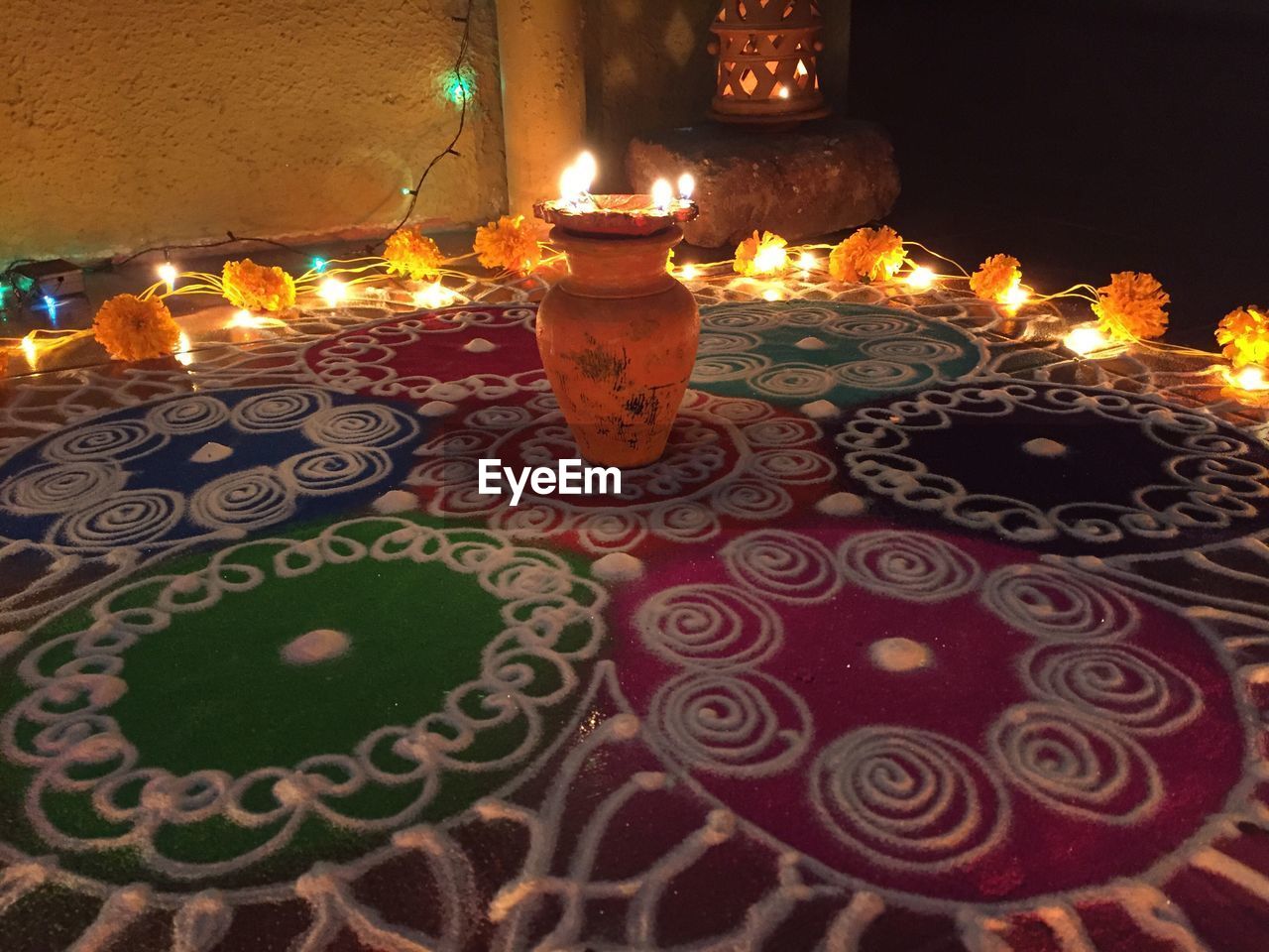 CLOSE-UP OF ILLUMINATED CANDLES