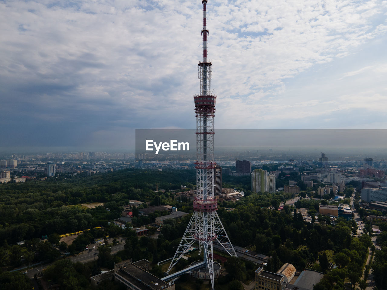 AERIAL VIEW OF CITY BUILDINGS AGAINST CLOUDY SKY