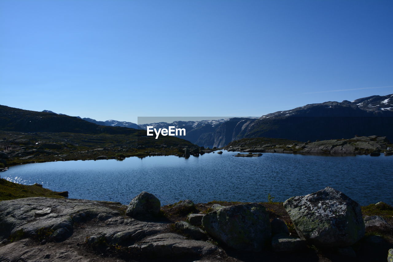 Scenic view of mountains against clear blue sky