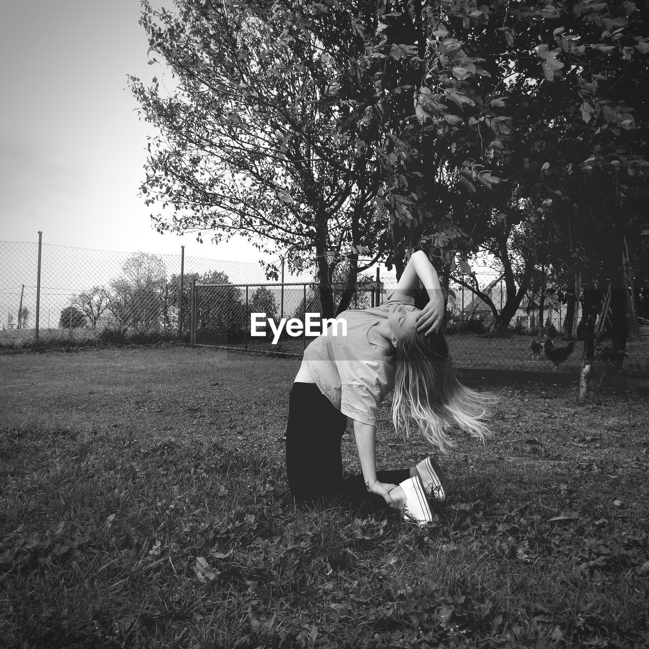 Young woman dancing on grassy field in park