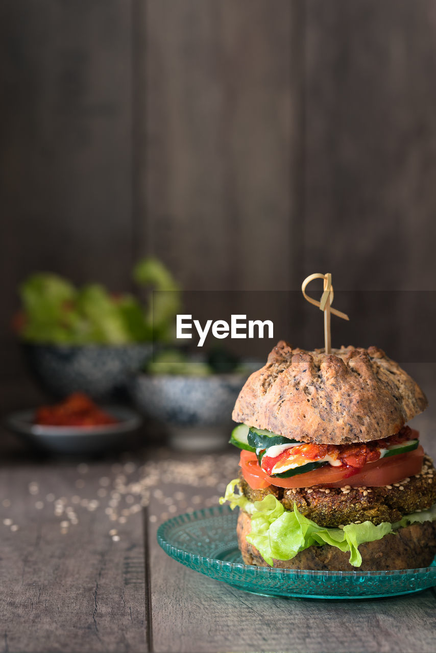 Close-up of burger in plate on wooden table