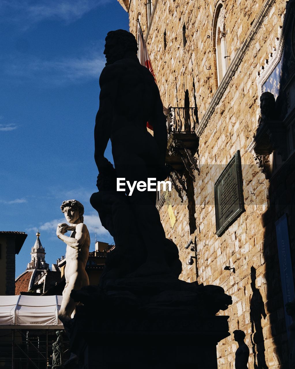 Low angle view of statue against historic building