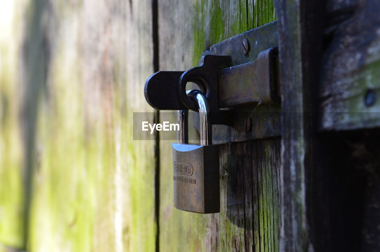 CLOSE-UP OF PADLOCK ON METAL DOOR