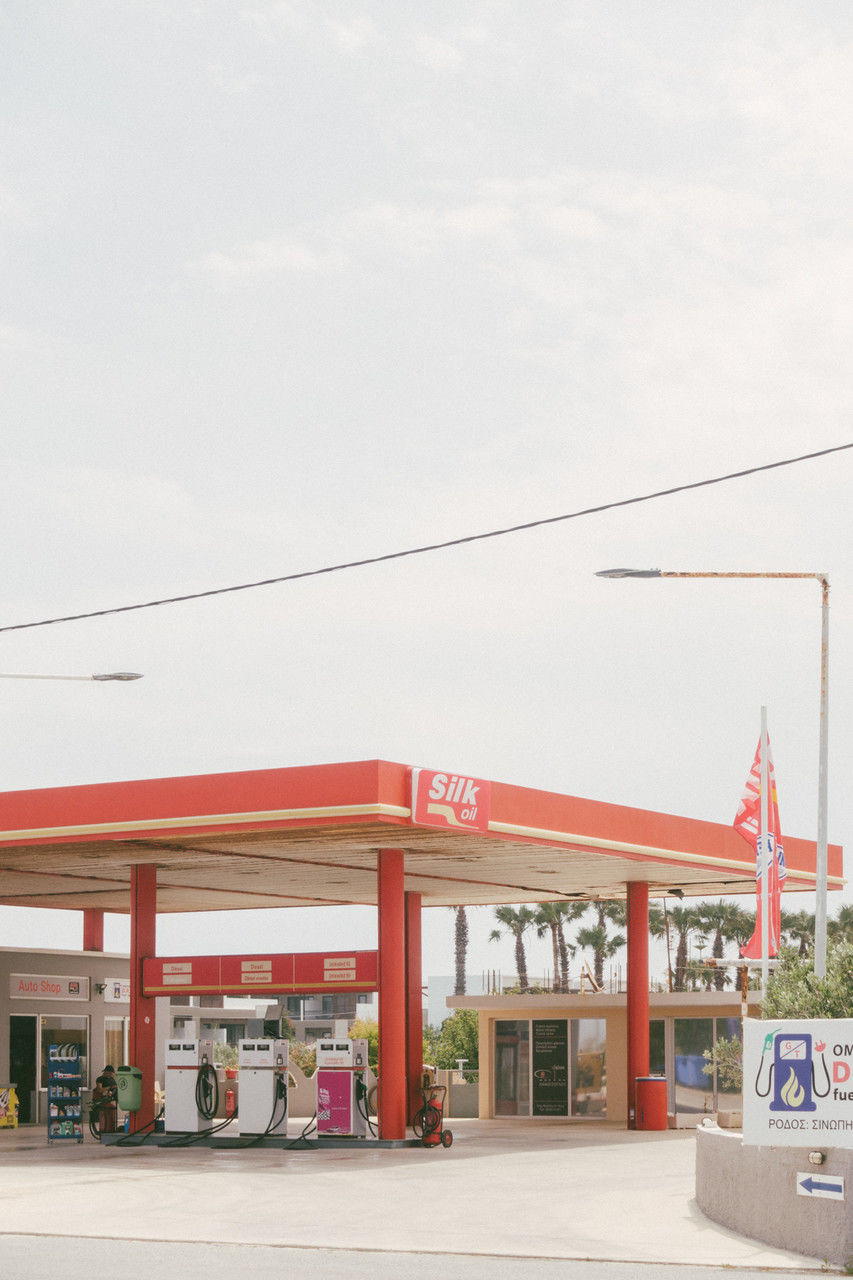 gas station, architecture, built structure, building exterior, sky, power generation, nature, no people, day, transportation, store, building, fuel pump, retail, business, outdoors, city, copy space, red, gasoline, mode of transportation, shopping, street, text