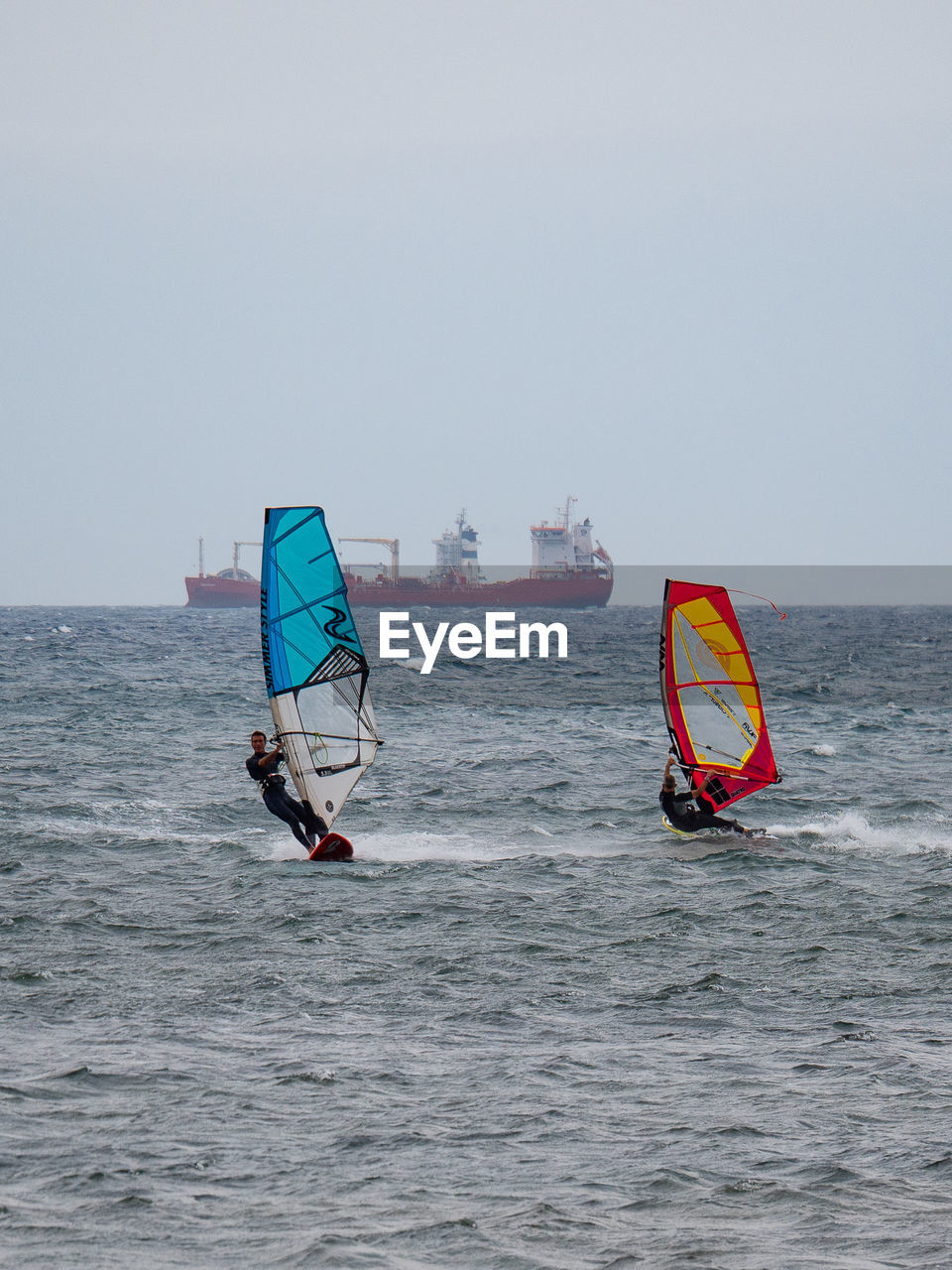 PEOPLE IN SEA AGAINST SKY