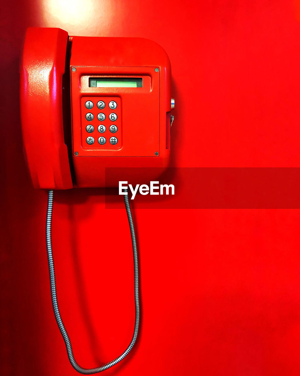 Close-up of red telephone on wall